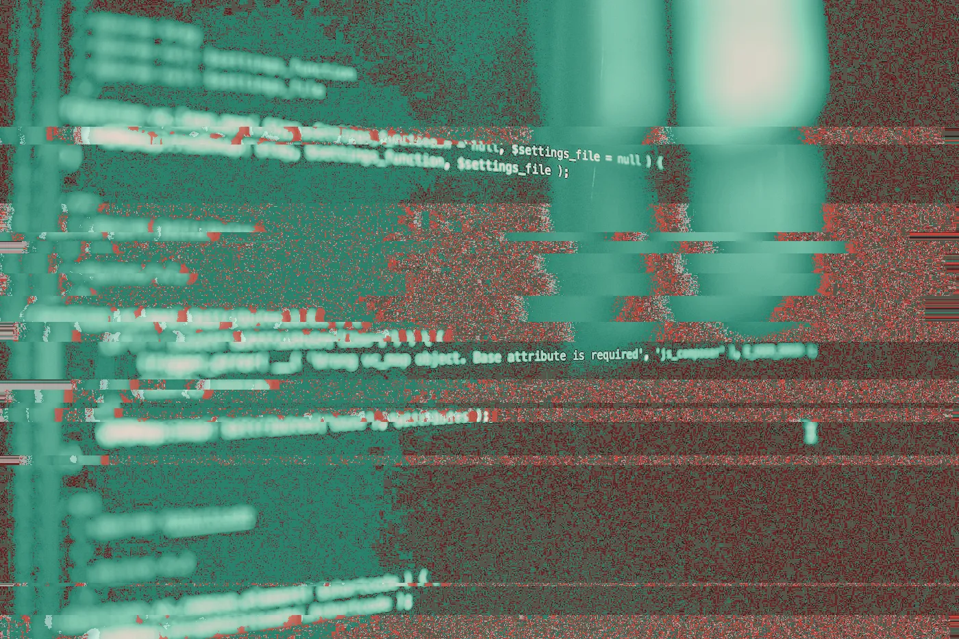Blurred PHP code on a dark monitor with one line in red