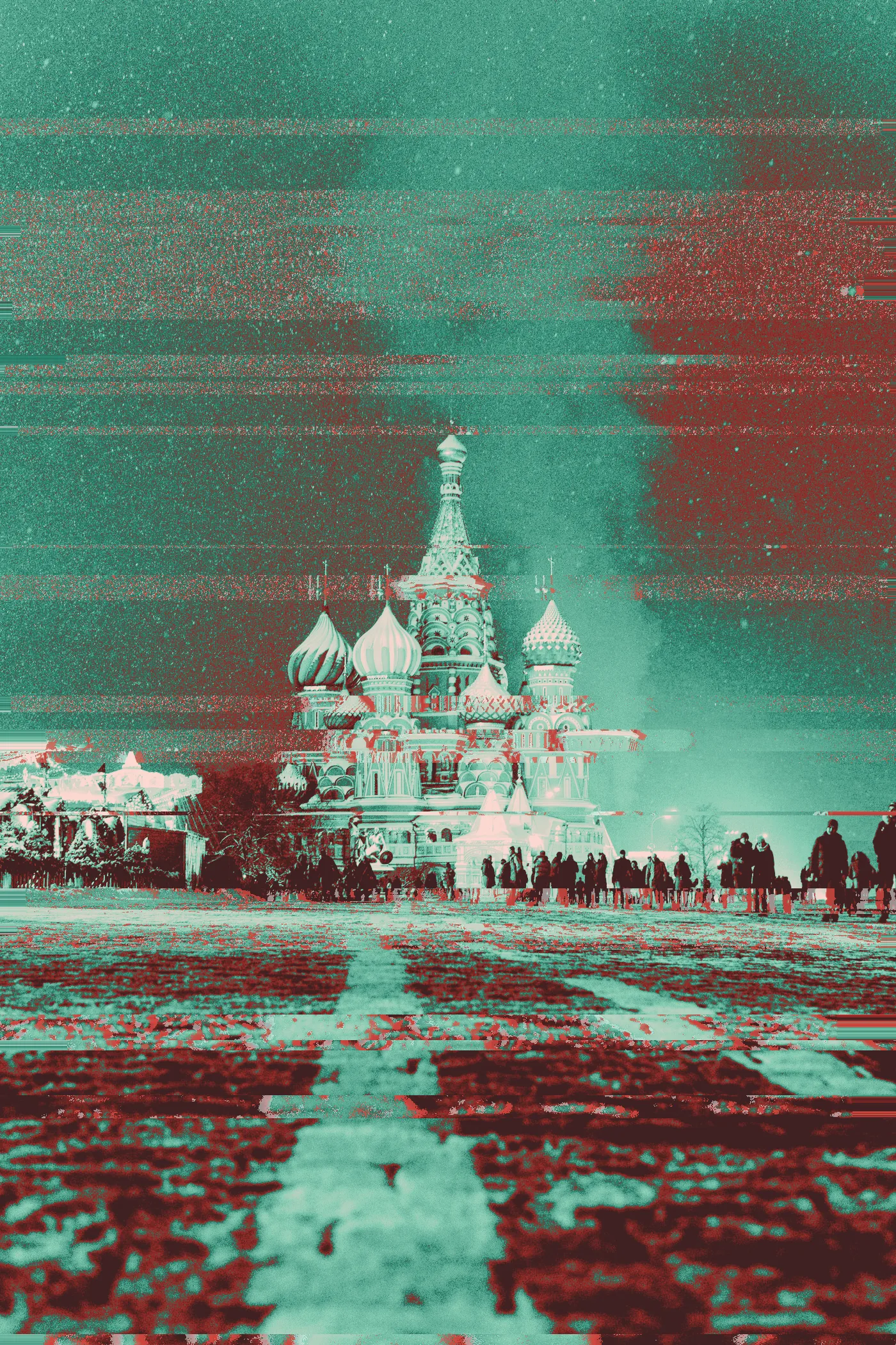 St. Basil's Cathedral in Moscow lit up at night, with crowds in the snowy square