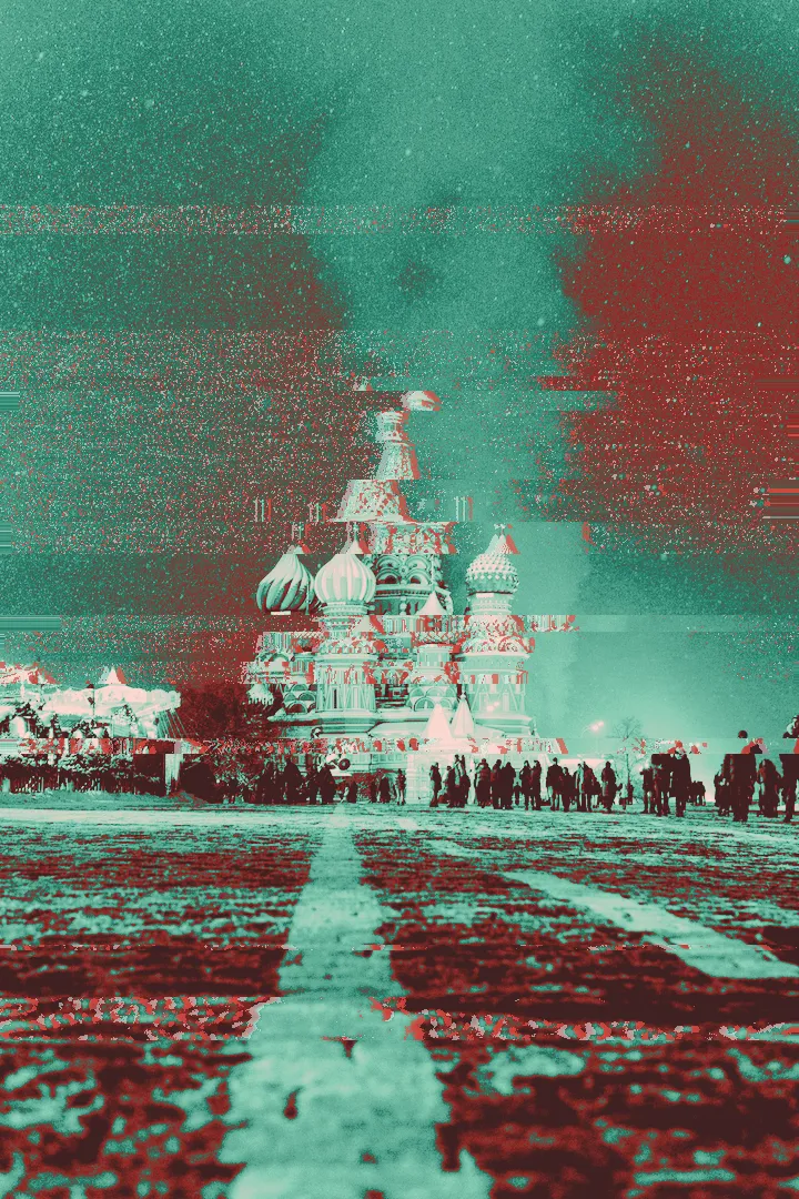 St. Basil's Cathedral in Moscow lit up at night, with crowds in the snowy square
