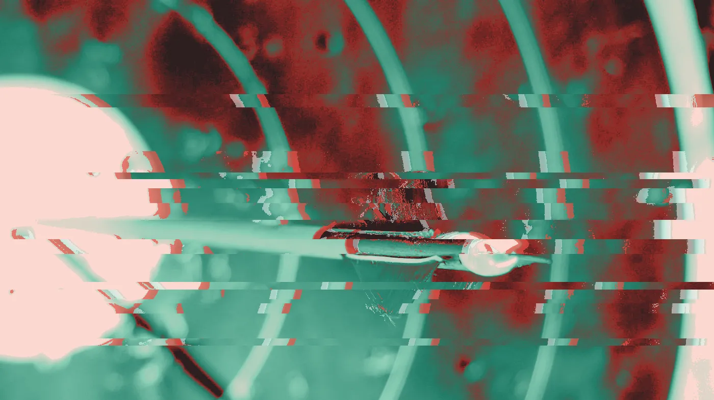 Dart with red flights stuck near the yellow bullseye of a target