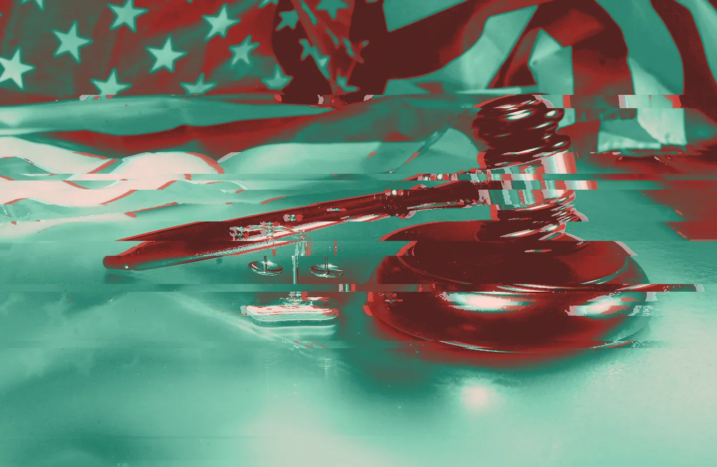 Gavel and scales of justice in front of a US flag lit in blue and purple