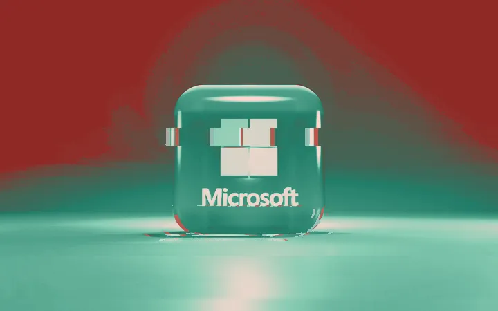Microsoft logo on a glowing translucent cube against a dark background